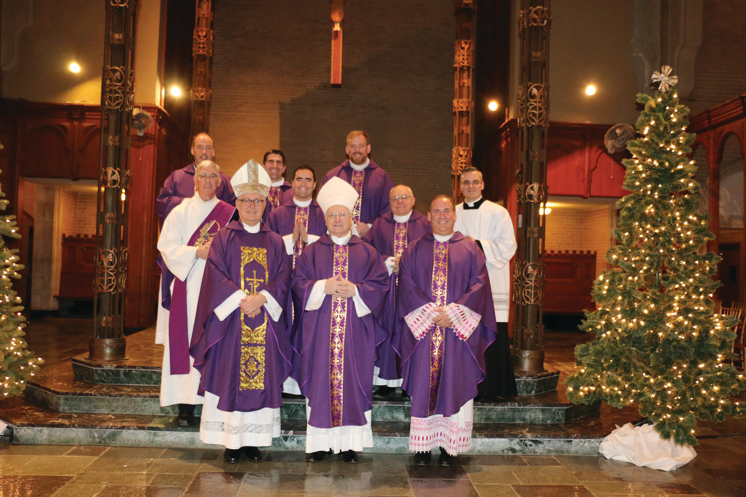 Bishop Tobin and clergy are pictured with Bishop Evans following Mass held prior to the diocesan employee Christmas dinner on December 11.